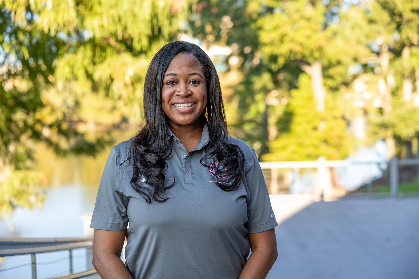 Portrait of Areah Thompson ULM Alumni Association Board Member, standing on campus near the bayou.