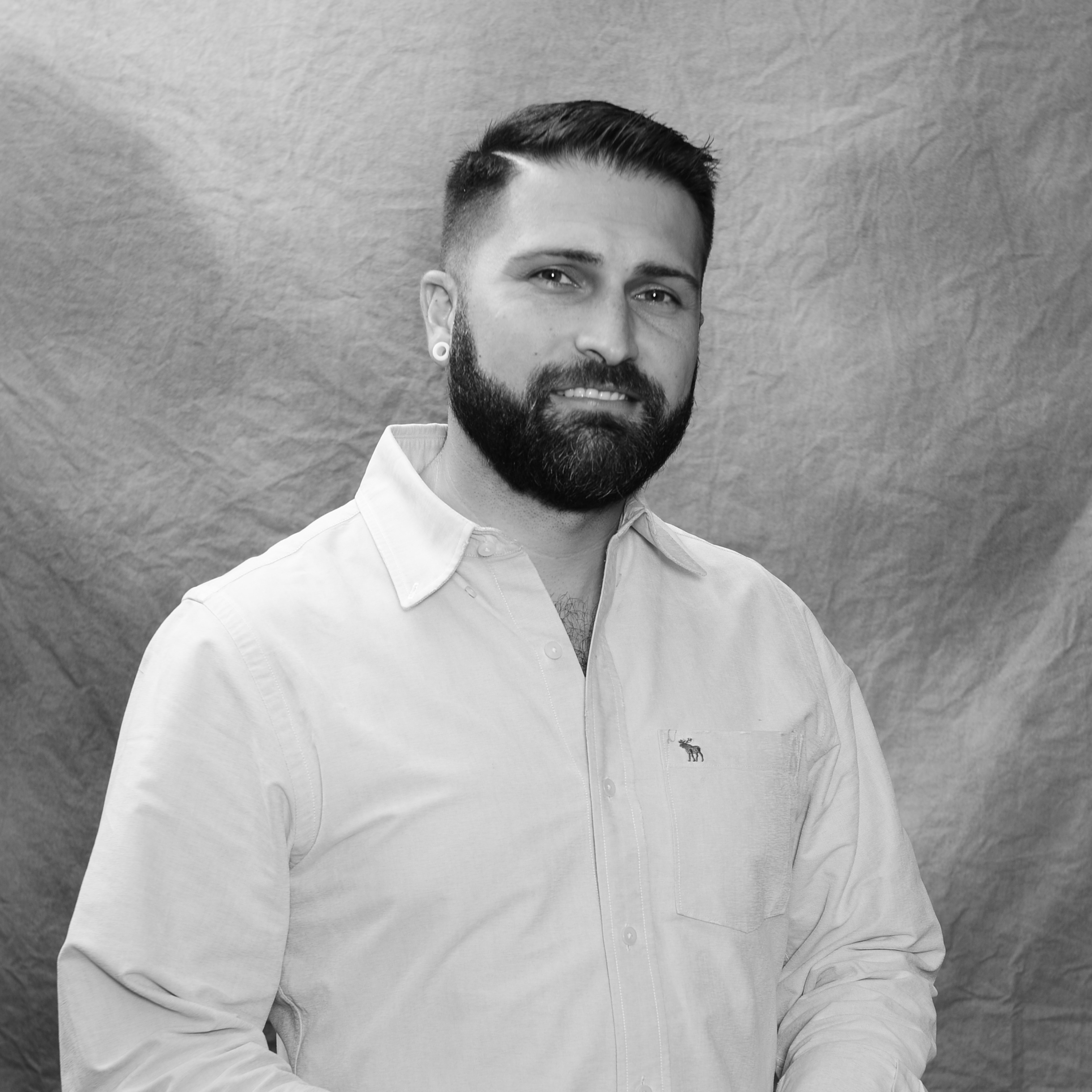 Portrait of Josh Carroll ULM Alumni Association Board Member, standing on campus near the bayou.