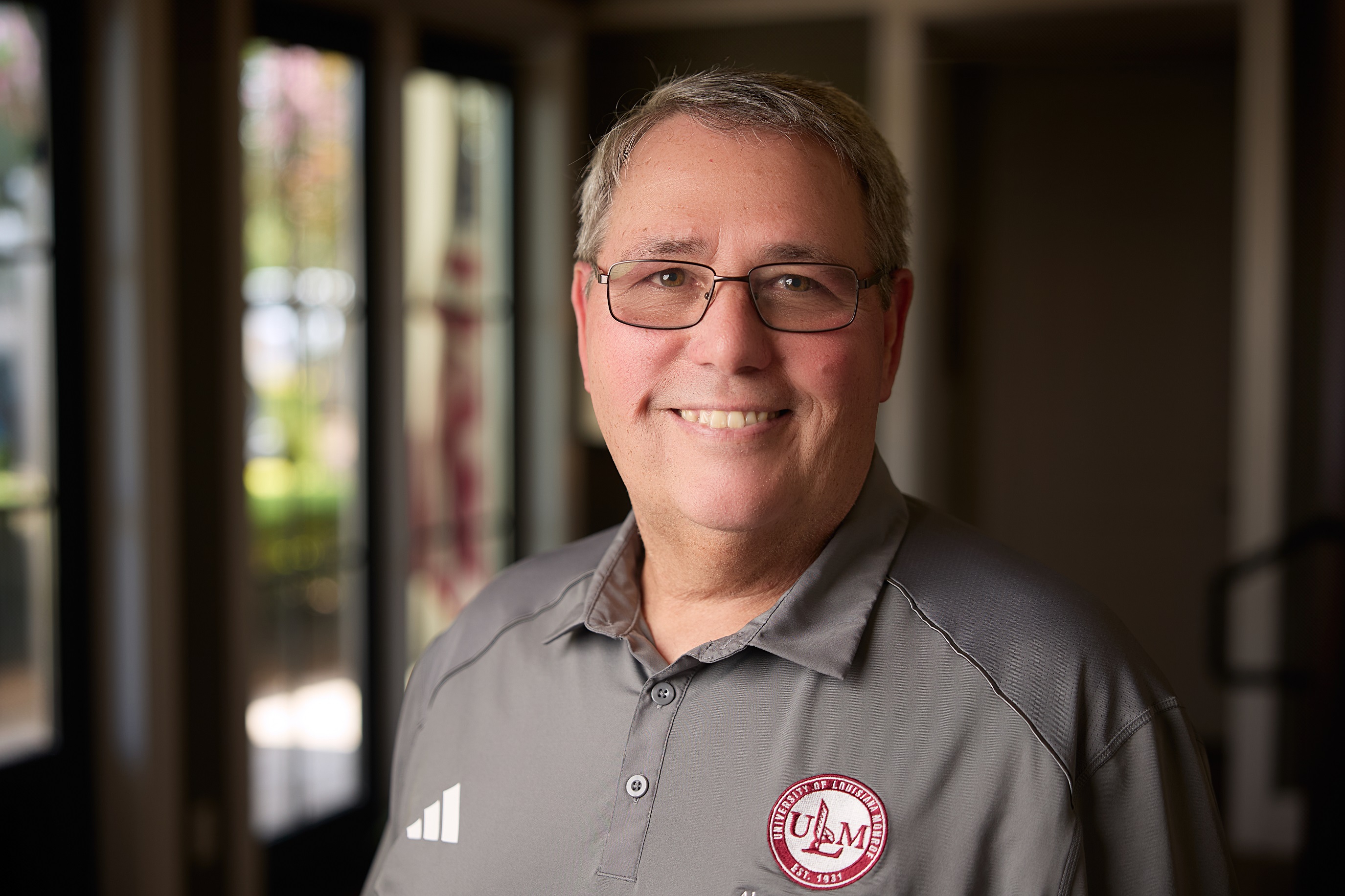 Portrait of David Smith ULM Alumni Association Board Member, standing on campus near the bayou.