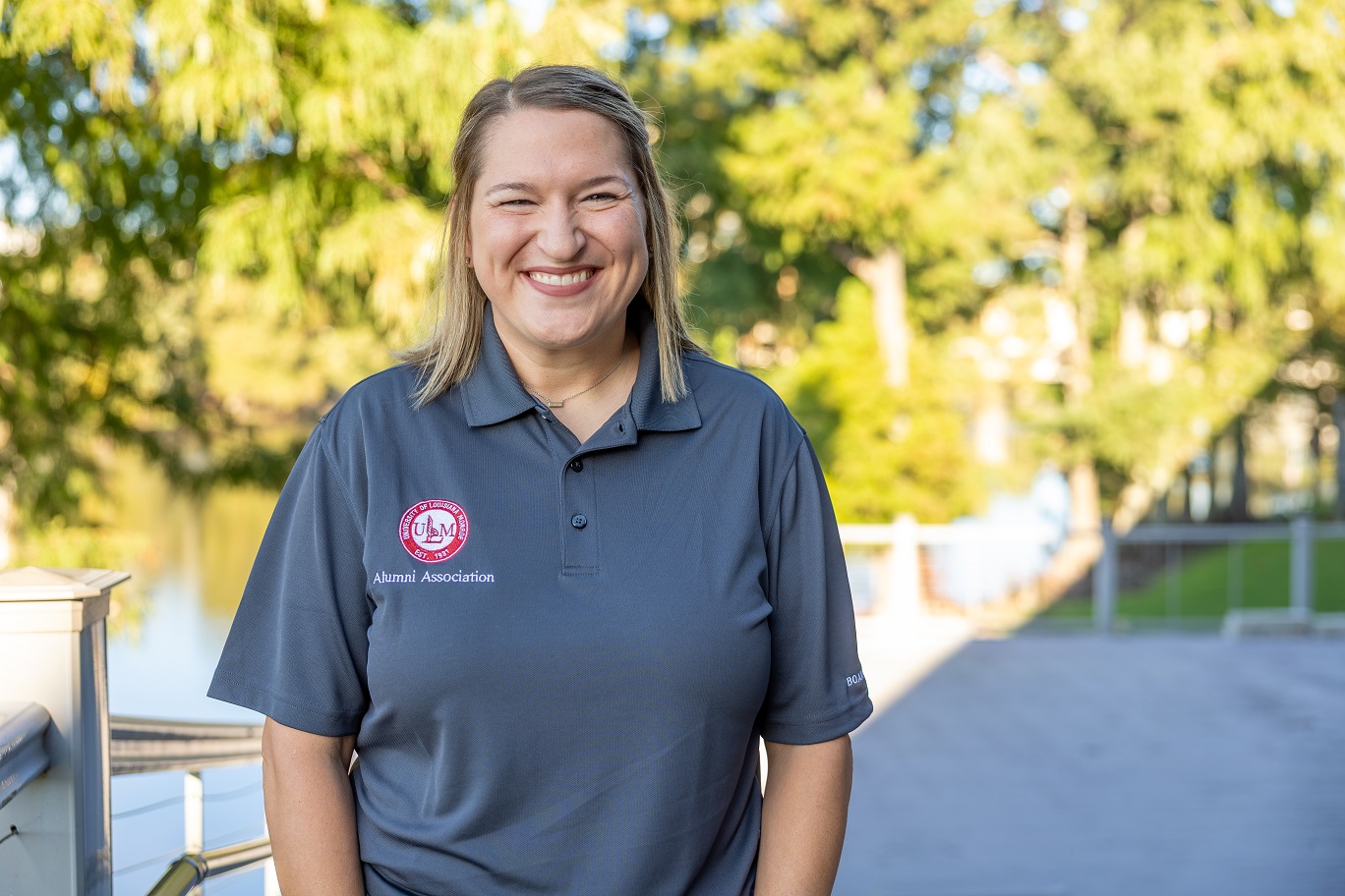 Portrait of Maggie Generoso, ULM Alumni Association Board President, standing on campus near the bayou.