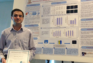 Hisham Qosa with his poster presentation award. Photo of Hisham Oosa